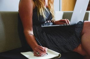 female entrepreneur on her laptop planning and budgeting for her startup