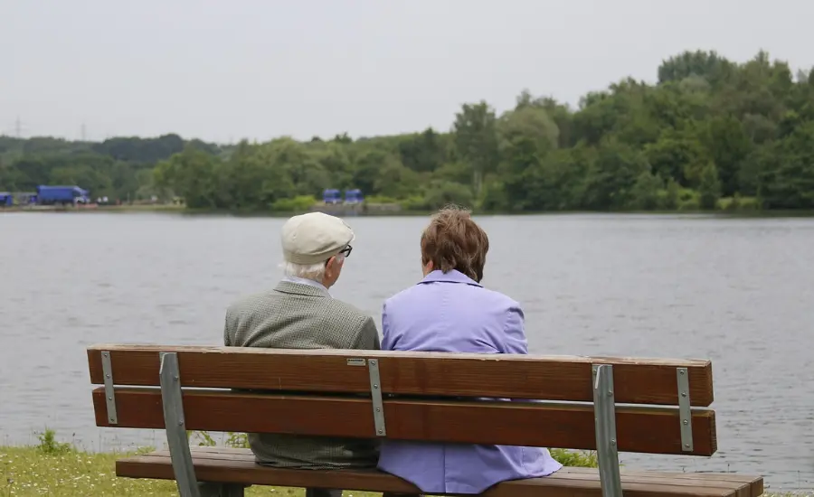 retired couple sitting on a bench