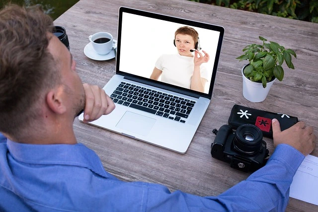man participating in a webinar on his laptop