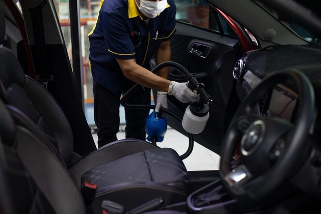 a worker cleaning a car at a car wash