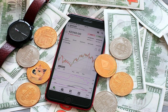 cryptocurrency trading showing a mobile phone with candlestick charts and fiat cash around along with crypto coins