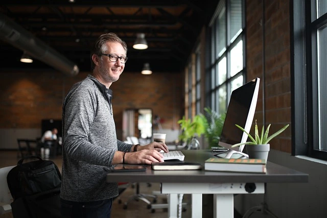 small business owner sitting at a desk with a laptop
